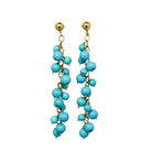 Turquoise beaded earrings set in 14k gold on a white background.