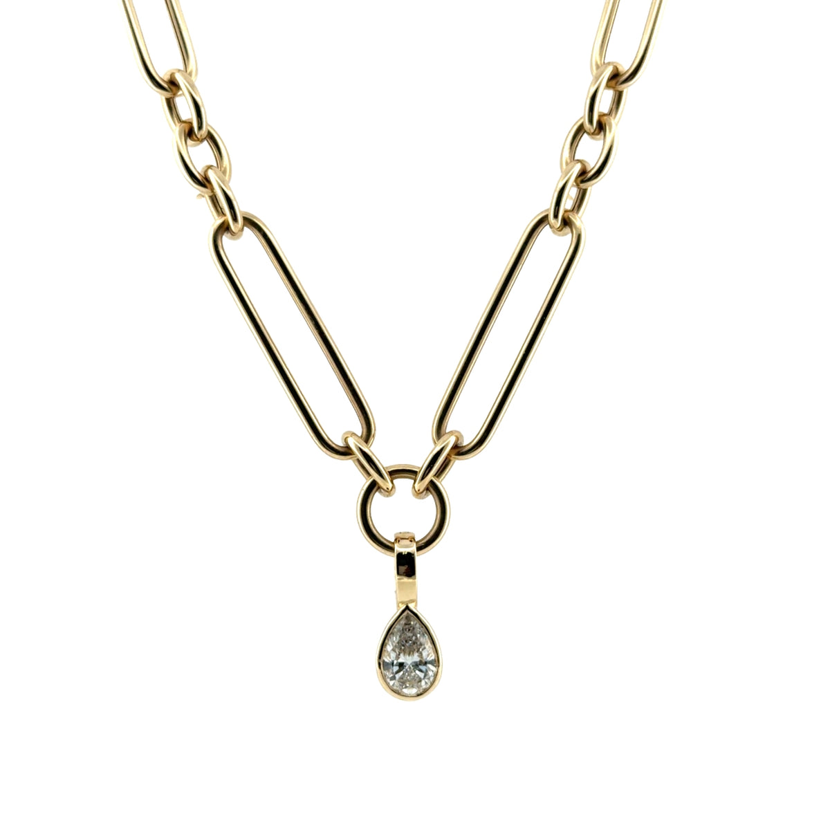 A close-up of a pear lab grown diamond pendant, set in 14k gold on a chunk chain all on a white background. 