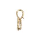 The side angle of a 14k gold bezel set pendant with a bail clip on a white background. 