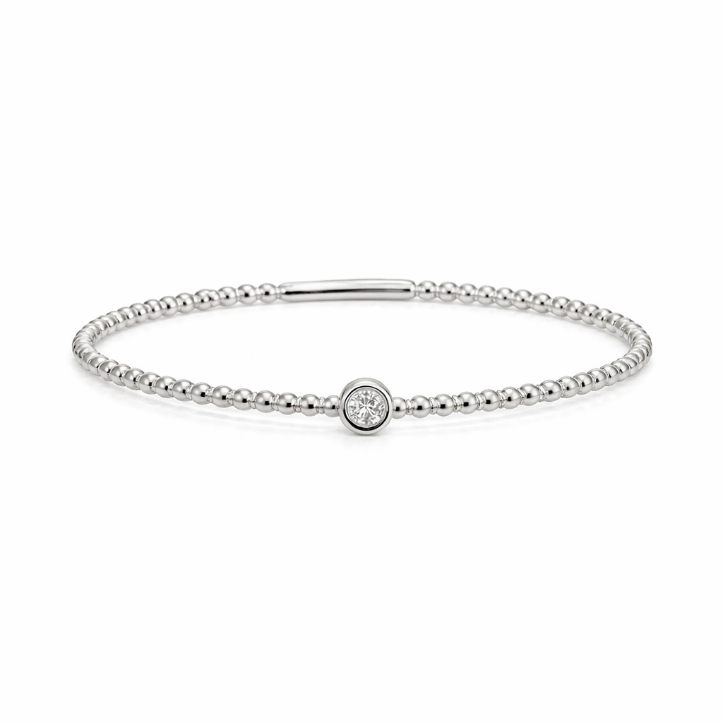 White gold bracelet with a small round gemstone on a white background