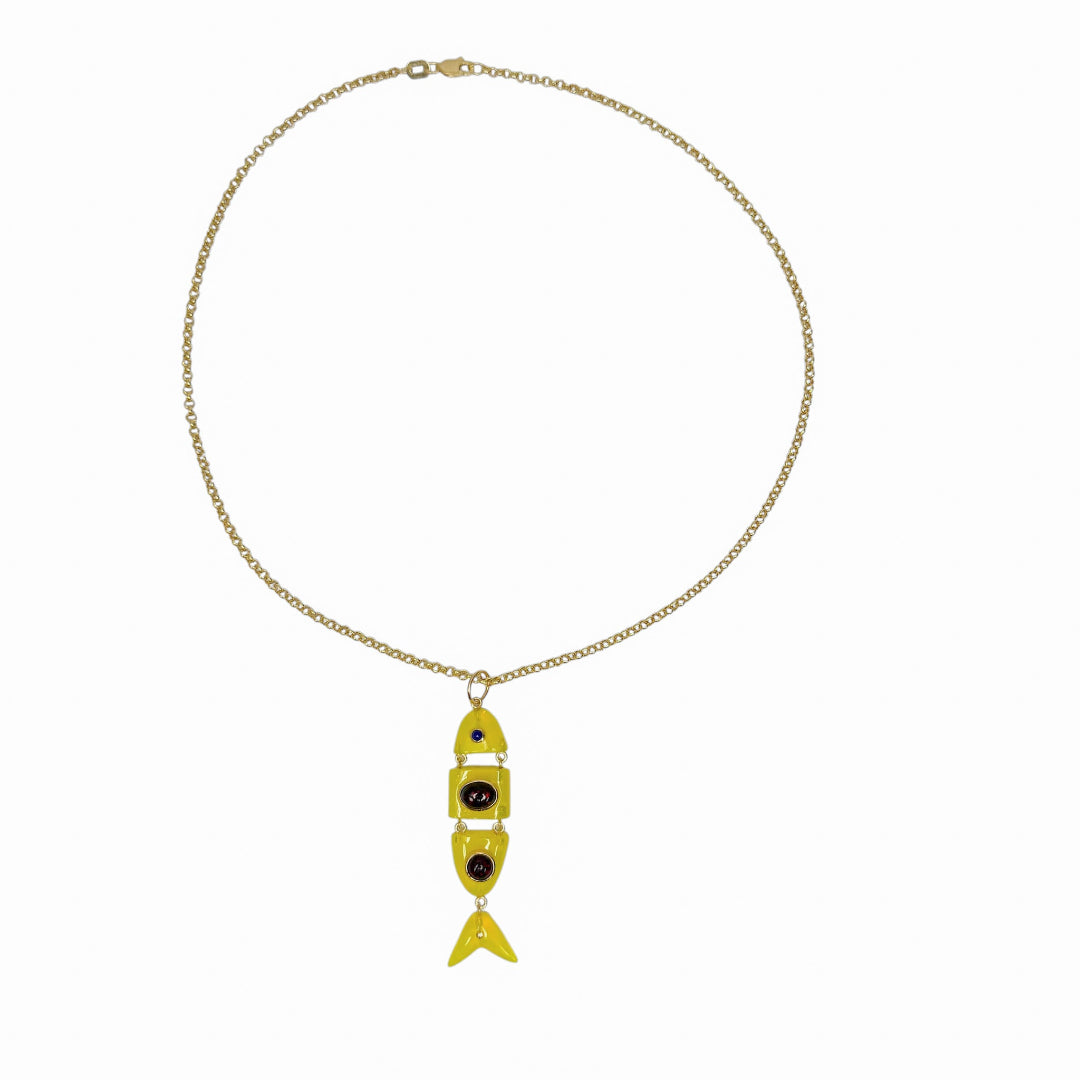 Gold necklace with a yellow fish-shaped pendant on a white background.