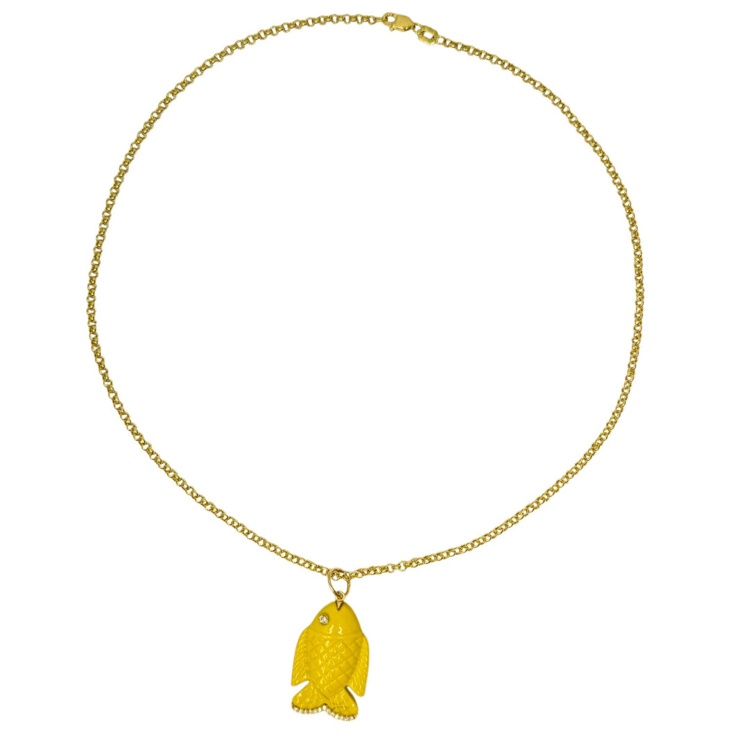 A 14k gold necklace with a yellow agate and diamond fish pendant on a white background. 