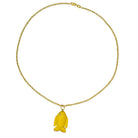 A 14k gold necklace with a yellow agate and diamond fish pendant on a white background. 