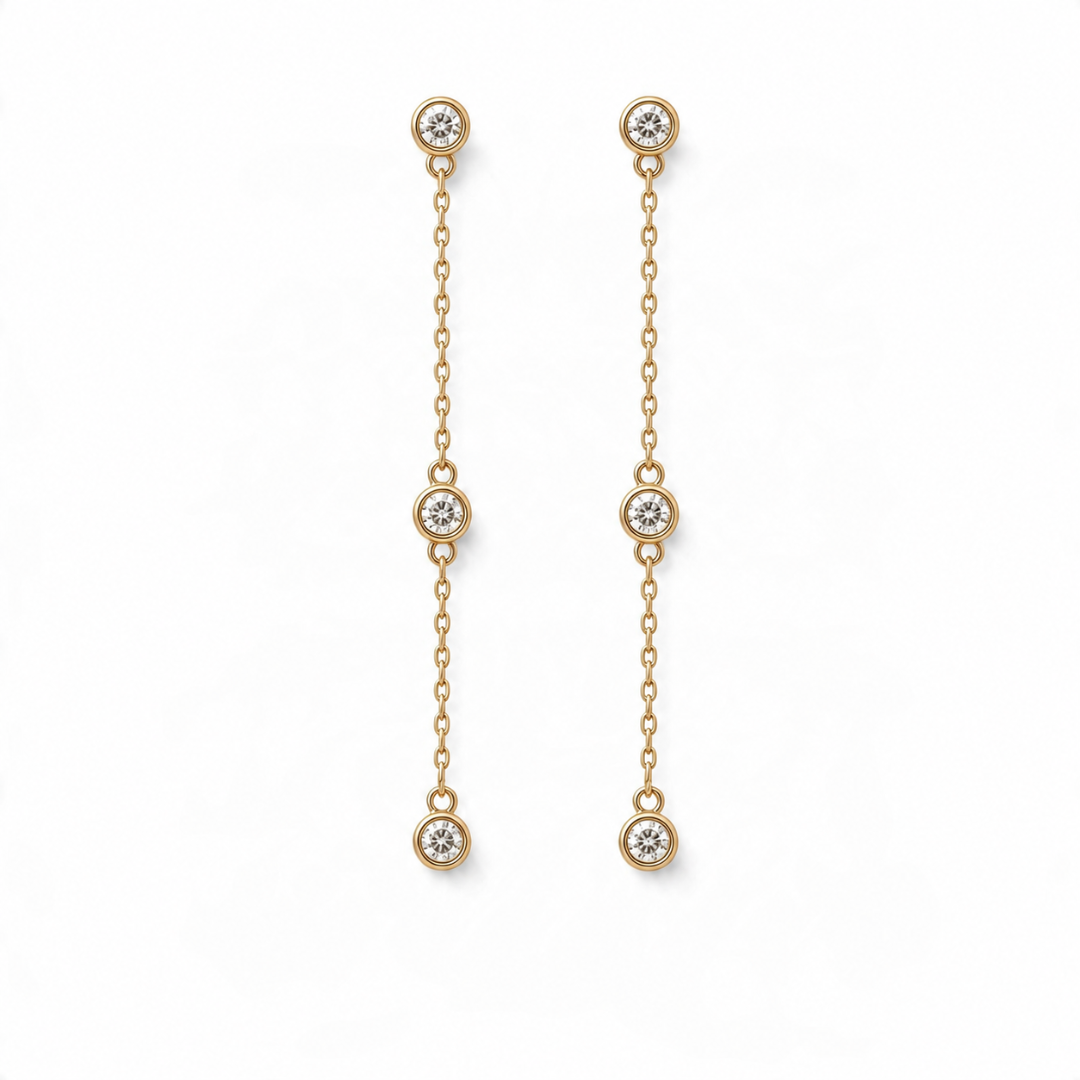 14k yellow gold diamond station drop earrings on a white background. 